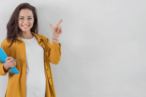 smiley-pregnant-woman-holding-clipboard-pointing-up-with-copy-space